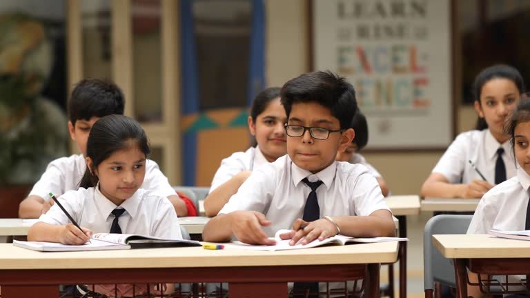 group of students studying book at classroom